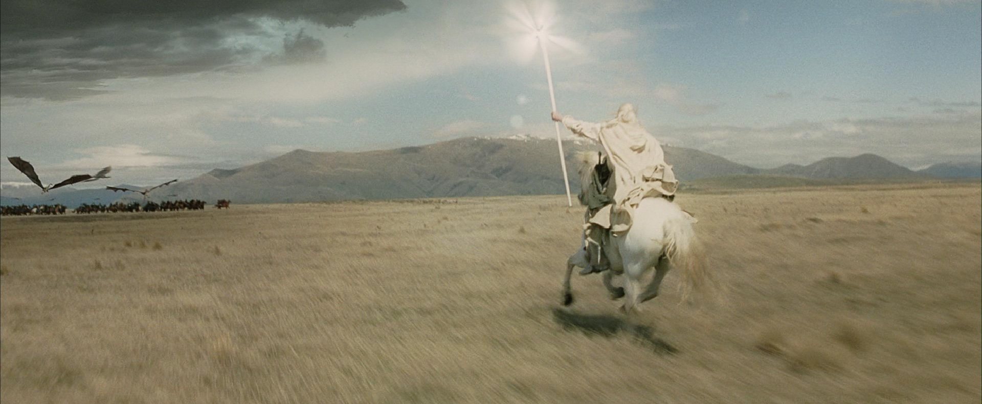 Gandalf the White (Sir Ian Mckellen) conjures a beam of light to ward off the Nazgul as he rides to bring the garrison from Osgiliath into Minas Tirith in The Lord of the Rings: The Return of the King (2003)